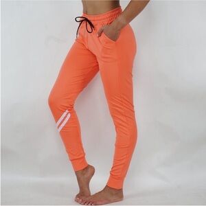 116. Women's Orange Jogger Pants Size Medium